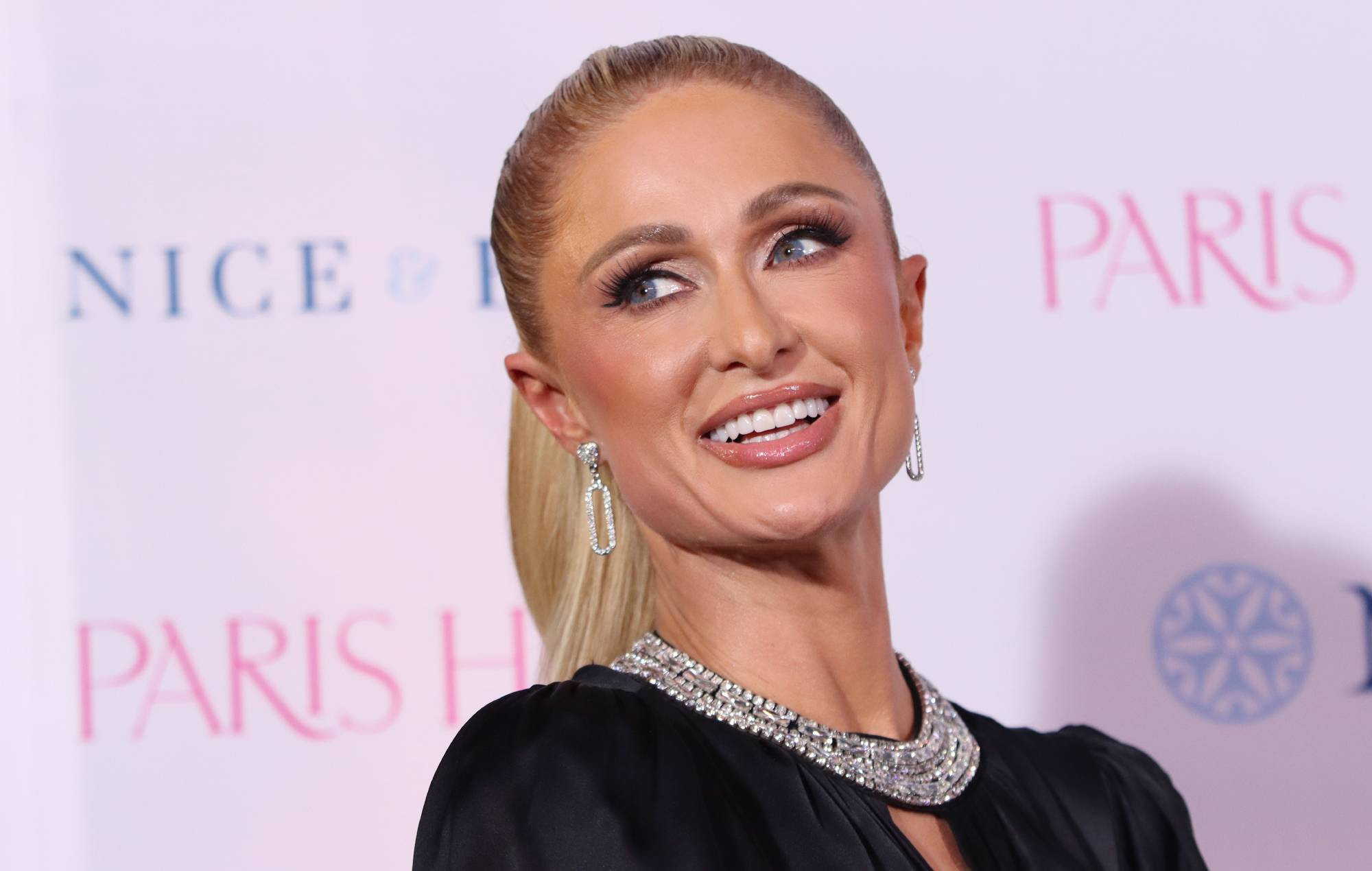 Paris Hilton Promotes New Album 'Infinite Icon' With Chic, Edgy Merch Look