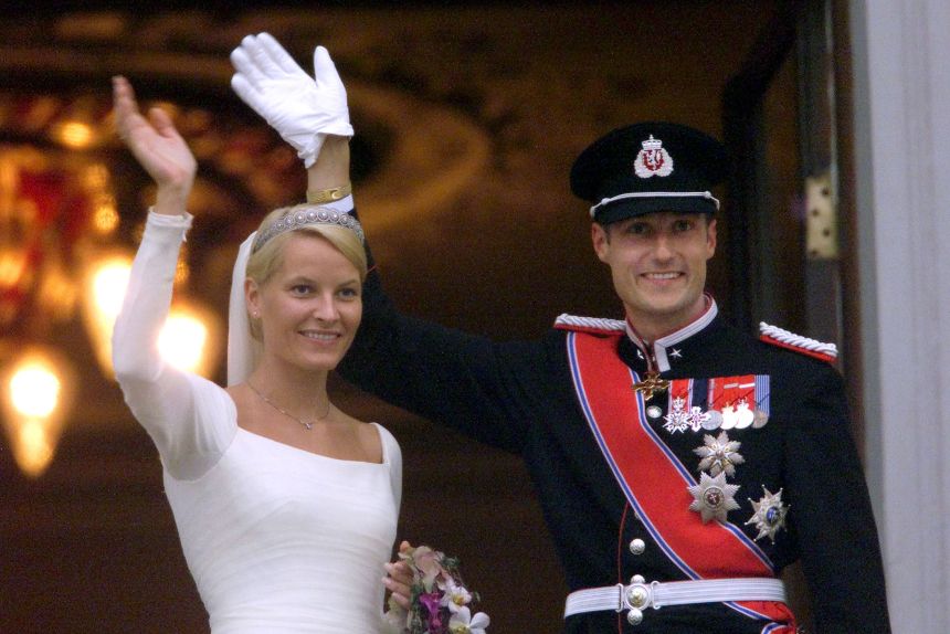 Then-Crown Prince Haakon and Crown Princess Mette-Marit wave at well-wishers from the balcony of the Royal Palace after their wedding in Oslo in 2001.