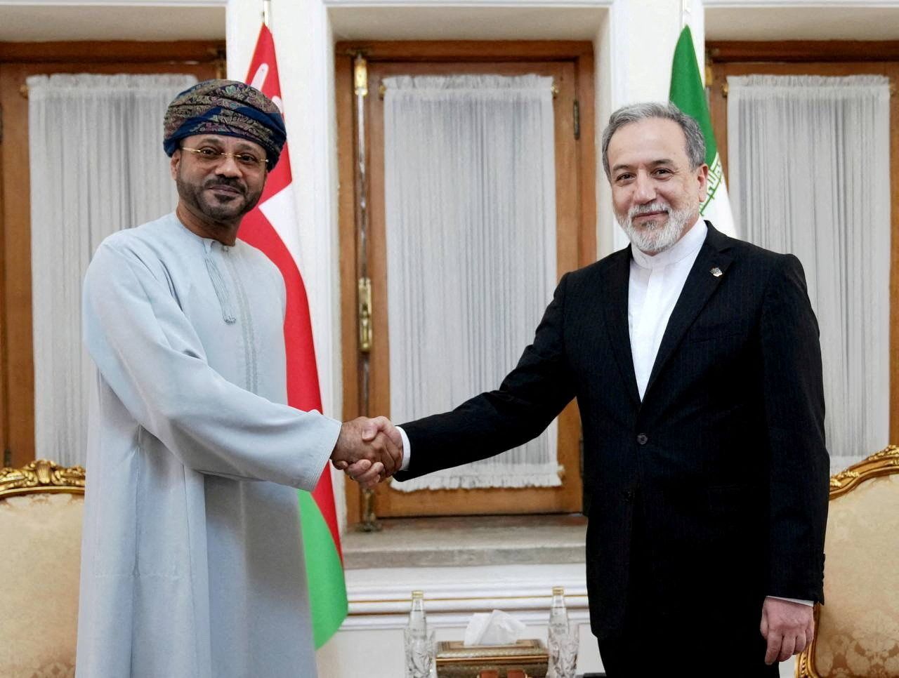 Abbas Araghchi meets with Oman's Foreign Minister Sayyid Badr al-Busaidi in Tehran, Iran, on Tuesday.
