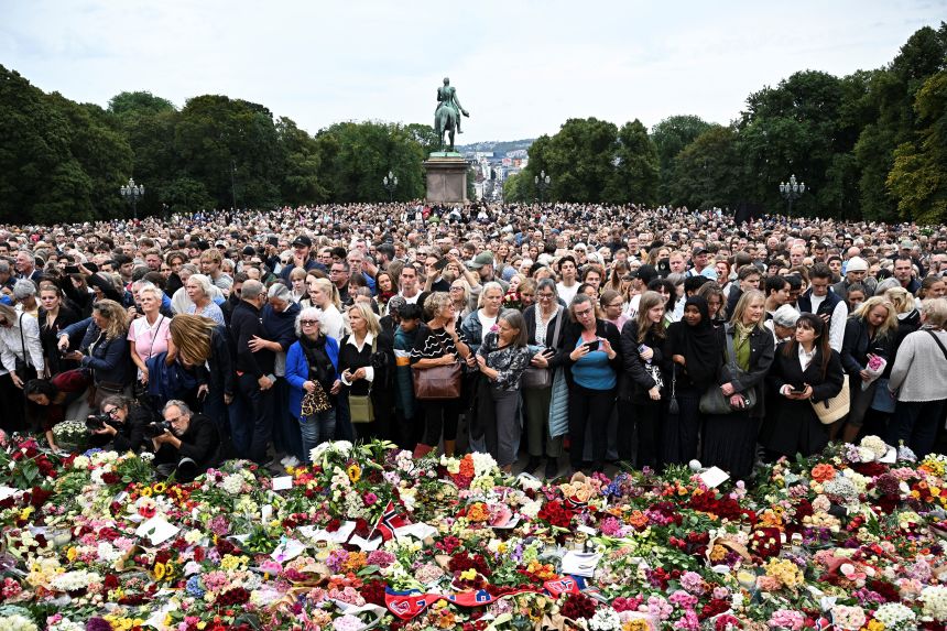 People gather to pay their respects outside the Royal Palace in Oslo on Friday following Harald's death, as the government declares a period of national mourning.