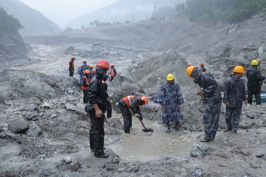 Rescue workers taking part in a rescue operation near the tunnel of the Trishuli 3A Hydropower Project, following deadly flash floods and mudslides.