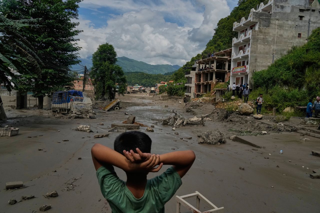A boy looks at the devastation caused by flash flooding along the Trishuli River in Nepal's Nuwakot district, Wednesday, Aug. 26.