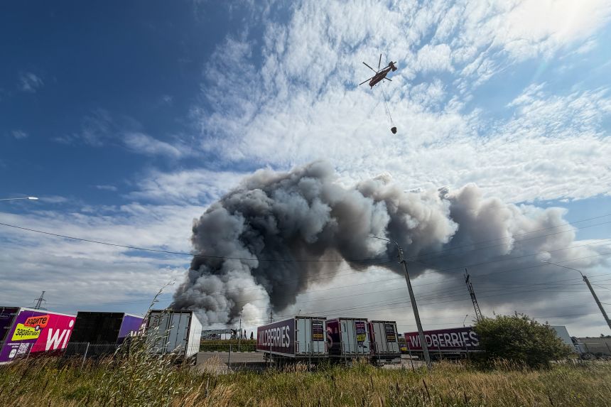 A helicopter prepares to drop water during a fire at Russian e-commerce firm Wildberries' logistics complex near the town of Podolsk, outside Moscow, on August 16.