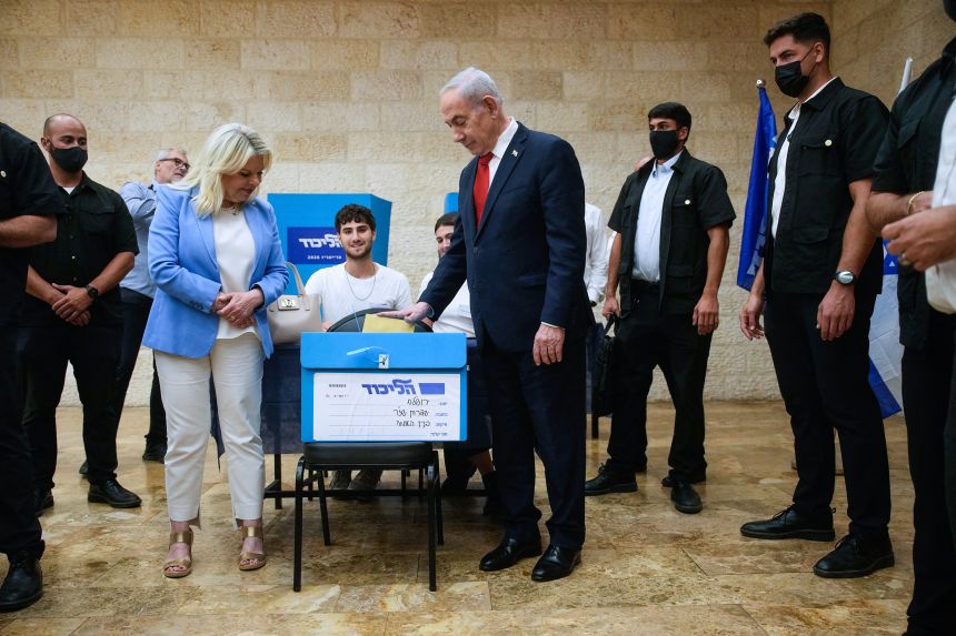 Israeli Prime Minister Benjamin Netanyahu, (C-R), and his wife, Sara, (C-L) cast their ballot at his party Likud's main polling station during primary elections ahead of Israel's general election in October in Jerusalem on August 17, 2026.